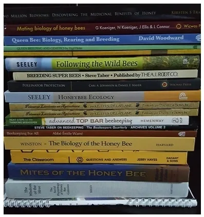 A stack of books with different titles on them.